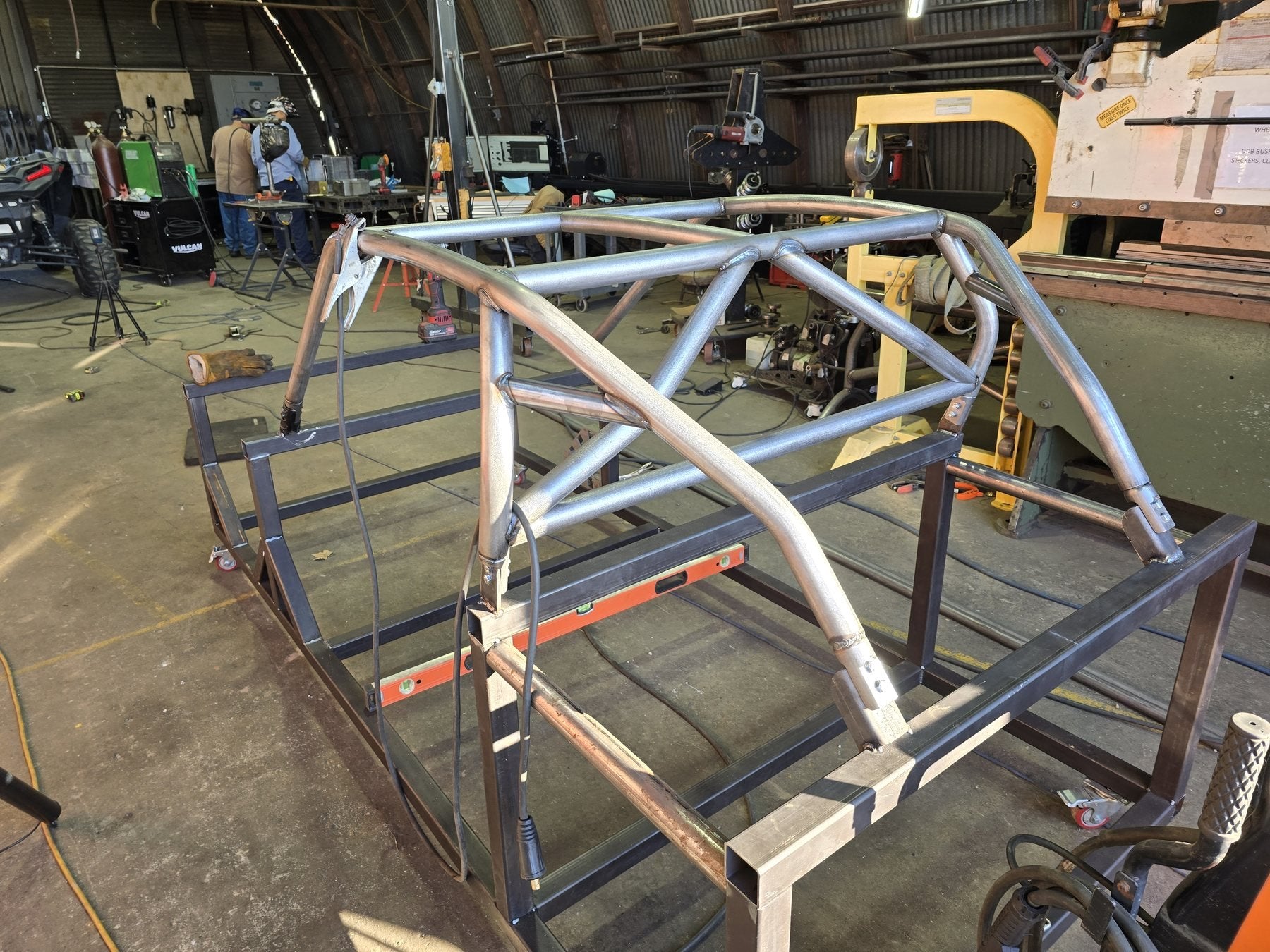Raw Tule Fab Works cage on a work table inside the Tulare shop